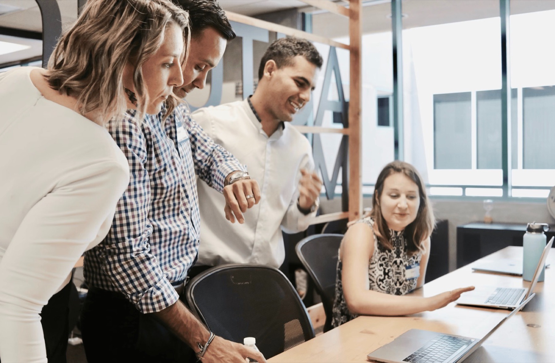 Sales team reviewing training material on a laptop